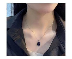 Close-up of a vintage S925 silver necklace with a rectangular deep purple gemstone pendant