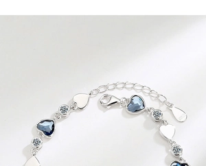 Detail shot of S925 sterling silver hallmark on the lobster clasp of a heart bracelet