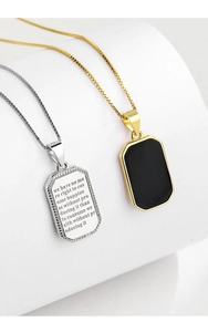 Detail of silver engraved rectangle pendant and gold pendant with black matte stone inlay