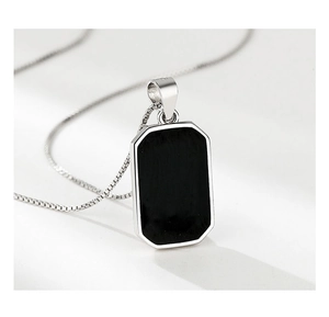 Detailed close-up of S925 sterling silver square pendant with black enamel and box chain