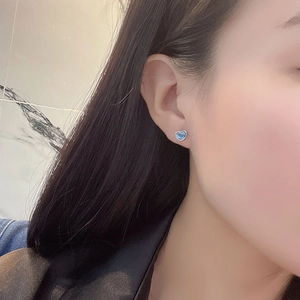 Elegant Heart of the Ocean silver stud earrings with blue crystal and polished metal edge