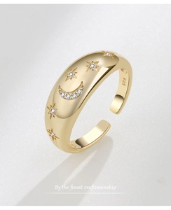 Macro shot of S925 hallmark on gold celestial ring with moon and star zircon details