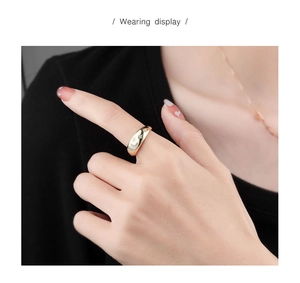 Wearing display of a gold crescent moon and star ring with sparkling zircons