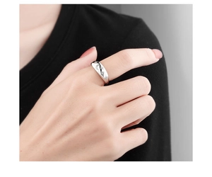 Close-up of s925 silver ring featuring moon and star engravings with crystals on finger