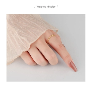 Detailed view of thin gold-plated S925 silver ring with a unique foil texture on finger