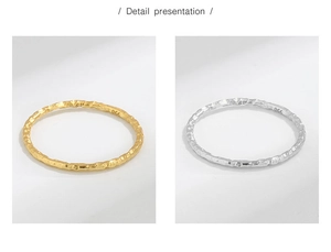 Detailed close-up of textured gold and silver stackable rings with hammered finish