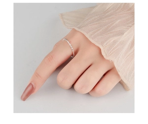 Macro detail of minimalist S925 sterling silver ring featuring a hammered foil texture