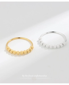 Macro detail of S925 sterling silver rings showing matte beads and hallmark engraving