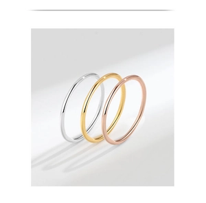Three minimalist stacked rings in silver, gold, and rose gold with polished finishes
