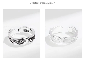 Close-up of S925 sterling silver angel wing rings showing polished and vintage finish details