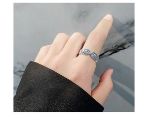 Macro detail of S925 sterling silver angel wing ring showing intricate feather textures