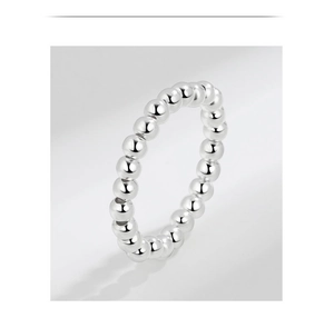 Dettaglio macro di un anello elastico minimalista in argento sterling S925 con perline