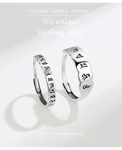 Macro shot of S925 sterling silver ring showing polished finish and religious engraving