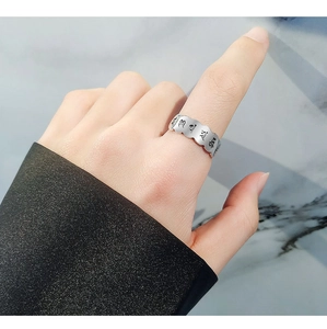 Macro detail of S925 sterling silver ring with wave edges and Sanskrit engraving
