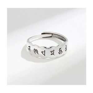 Detailed macro view of S925 sterling silver ring with engraved Buddhist mantra symbols