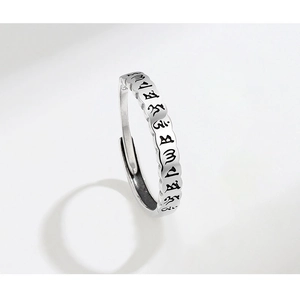 Macro detail of S925 sterling silver ring with engraved vintage Buddhist mantras