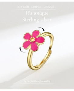 Detail of S925 silver spinning ring with pink enamel flower and adjustable gold band