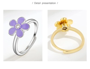 Detailed macro view of enamel flower ring showing adjustable band and gold plating quality