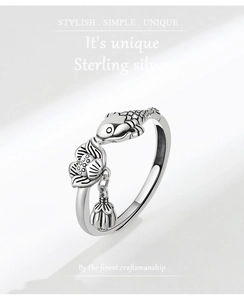 Close-up of a vintage S925 sterling silver ring featuring carved koi and lotus pendant