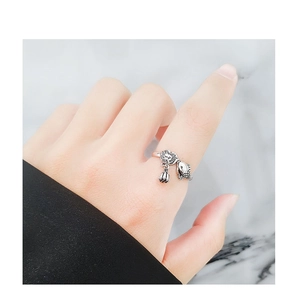Detail of s925 silver koi fish ring with lotus tassel pendant on a female finger