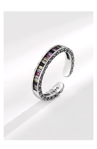 Macro detail of S925 sterling silver ring featuring colorful zircons and embossed pattern