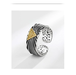 Detail showing the All-Seeing Eye symbol and ornate vintage carvings on the silver ring