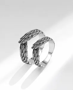 Macro detail of sterling silver feather rings with vintage oxidized metal texture