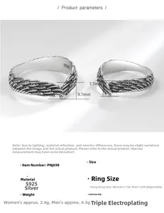 Macro detail of S925 sterling silver wing rings with adjustable band and engraved texture