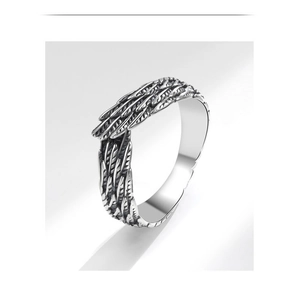 Macro shot of silver angel wing ring showing vintage feather textures and oxidized finish
