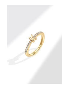 Macro detail of gold S925 silver letter K ring with sparkling zircon micro-pave stones
