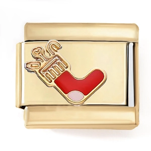 Detail of gold modular link charm with festive red and pink enamel Christmas stocking