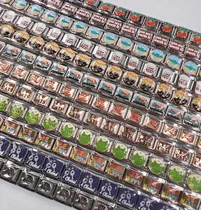 Macro display of DIY stainless steel Italian charm links with enamel phrases and symbols
