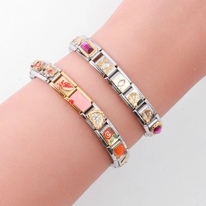Detail of Italian charm bracelets featuring butterfly and heart charms on a wrist