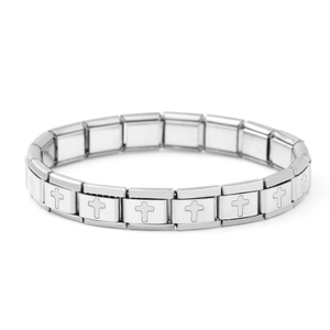 Detailed macro shot of silver stainless steel modular Italian charms with cross engravings