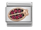 Macro detail of Italian charm link with rose gold ladybug and red crystal inlay