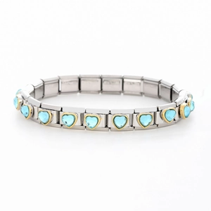 Macro detail of Italian style modular link bracelet with light blue heart gemstone and gold trim