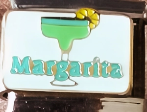 Macro shot of 9mm stainless steel charm link featuring enamel Margarita cocktail art
