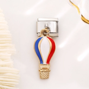 Macro shot of Italian charm link featuring a red white blue hot air balloon on stainless steel