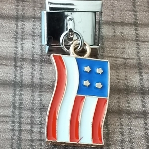 Macro detail of Italian charm link featuring a red white and blue flag pendant