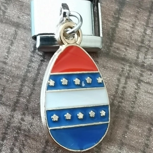 Macro view of an egg-shaped American flag charm with stars for modular bracelets