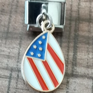Detail of water drop American flag charm on a stainless steel Italian link bracelet
