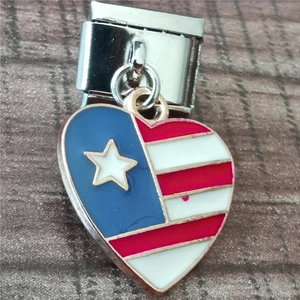 Macro detail of a heart charm with flag colors on modular stainless steel link