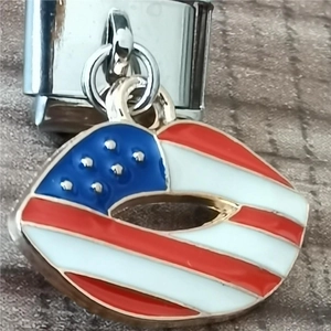 Macro view of US flag enamel charm with polished stainless steel link for Italian bracelets