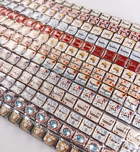 Macro view of 12-month series stainless steel modular Italian charms with enamel patterns