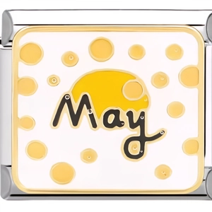 Macro shot of 9mm May month stainless steel charm with white enamel and yellow dots