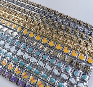 Detailed macro shot of stainless steel Italian charms with enamel patterns and crystals