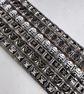 Detail of modular Italian charm bracelet with panda and skull icons on stainless steel links