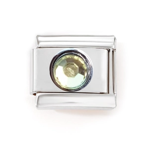 Macro detail of Italian modular charm with a yellow faceted gemstone in a silver steel frame