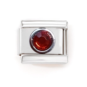 Detail of Italian modular charm link with a faceted red gemstone in polished stainless steel