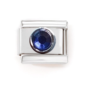 Macro view of modular Italian charm link with polished steel and blue cat eye stone
